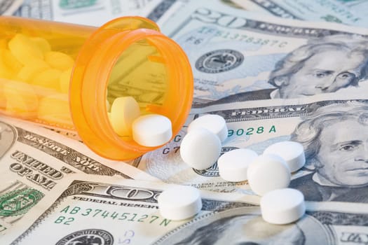 Close_up of medicines and a pill bottle on US paper currency