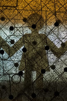 Close_up of a circuit board with shadow of a paper chain doll
