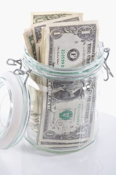Close_up of a jar of US dollar bills