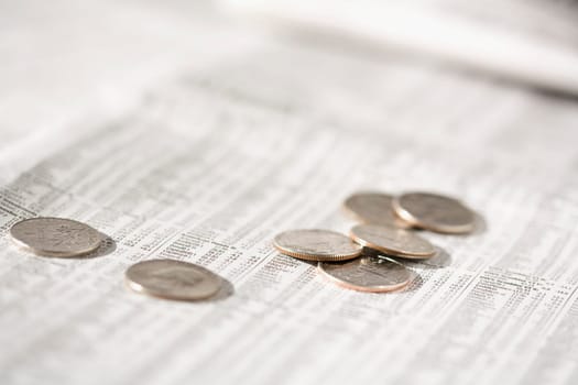 Close_up of coins on a financial newspaper