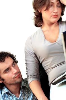 Young couple thinking while working on a laptop