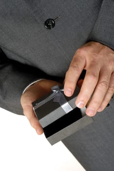 Mid section view of a businessman holding a gift
