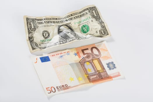 Close_up of a US dollar bill and fifty euro banknote