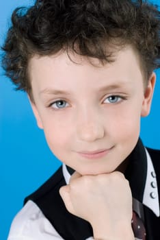 Portrait of a boy with his hand on his chin