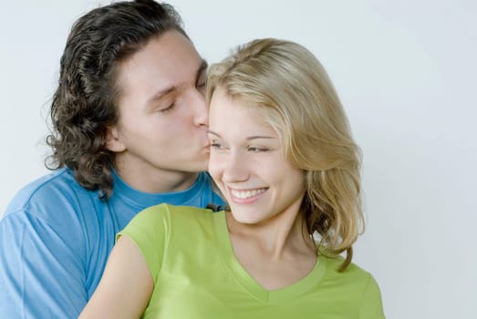 Close_up of a young man kissing a young woman