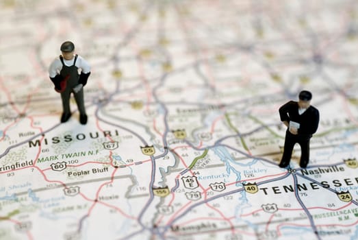 Close-up of the figurines of two construction workers on a map