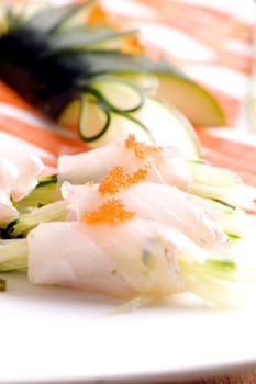 Close-up of prepared fishes topped with caviar in a plate