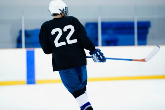 Rear view of an ice hockey player playing ice hockey