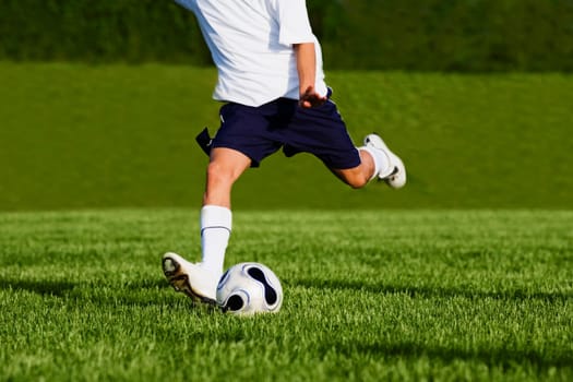 Low section view of a soccer player playing soccer