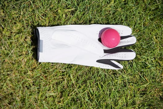 High angle view of a golf ball on a golf glove