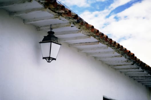 Low angle view of a lantern hanging from eaves