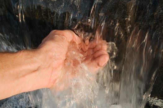 Close-up of a personŽs hand touching water