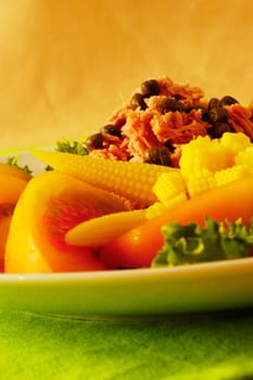 Close-up of tomato slices and baby corn on a plate
