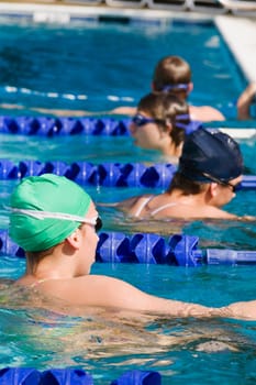 Four young women swimming in a swimming pool
