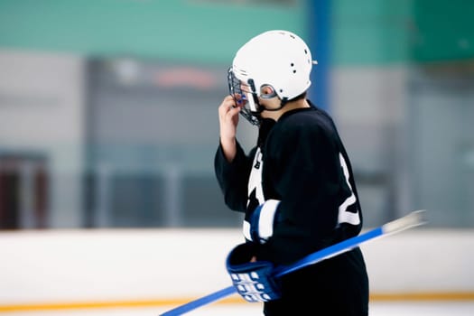 Side profile of an ice hockey player holding an ice hockey stick