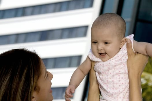 Mother holding up her daughter