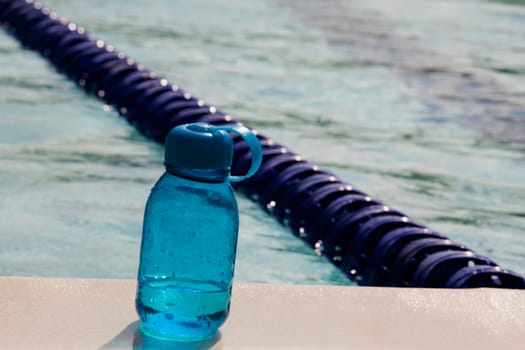 Close-up of a bottle at the poolside