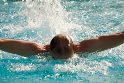Mid adult man swimming in a swimming pool