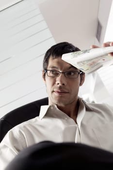 Close-up of a businessman holding a newspaper