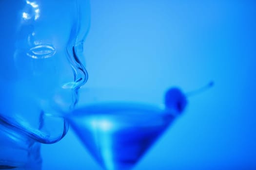 Close-up of a glass mannequin drinking a glass of martini