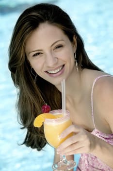 Portrait of a young woman holding a glass of juice