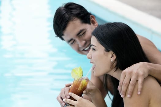 Side profile of a young couple holding a glass of drink