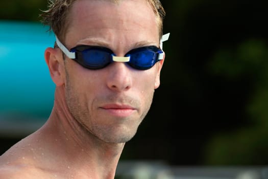 Close-up of a mid adult man wearing swimming goggles
