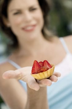 Close-up of a cupcake on a young womanŽs hand