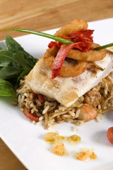 Close-up of rice and a fish fillet in a plate