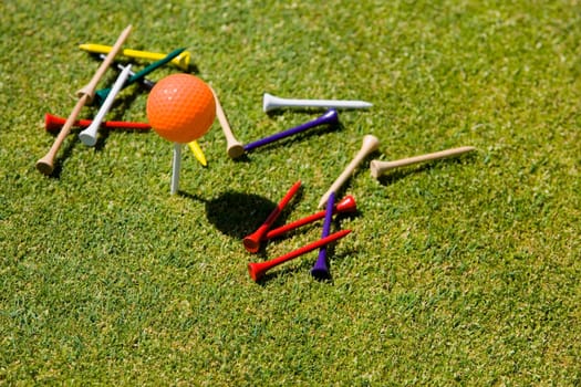 High angle view of a golf ball and tees