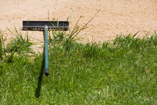 High angle view of a rake on sand