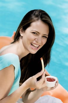 Portrait of a young woman eating french fries