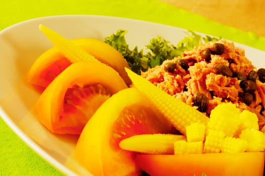 Close-up of tomato slices and baby corn on a plate
