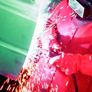 Welder welding a car door, Delaware, New York City, New York State, USA
