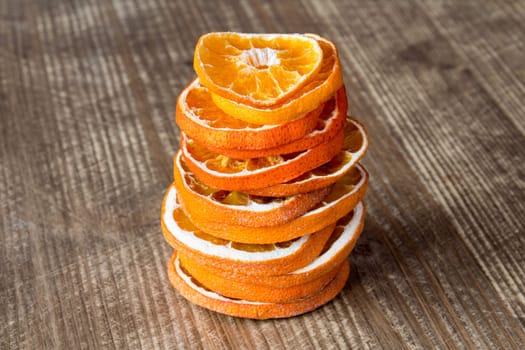 Stack from slices of orange fruit on the wooden background