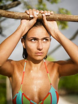 Close-up of a young woman holding a log