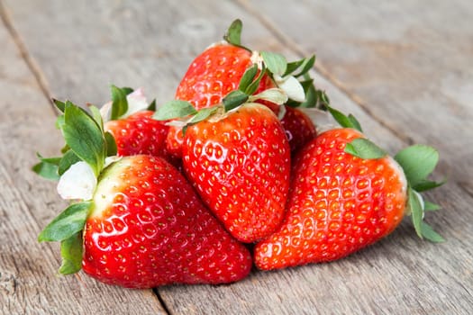 Pile of Fresh strawberries on wood table background