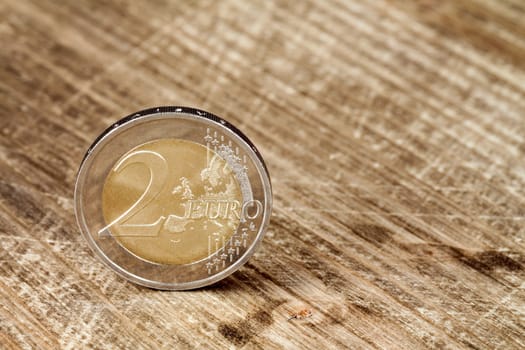 Two Euro coin on the wooden table surface