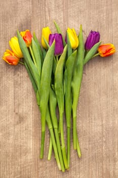 Bouquet of tulips on wooden background . Mother's Day background. Top view.