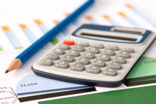 Close-up of a spreadsheet with calculator and pencil