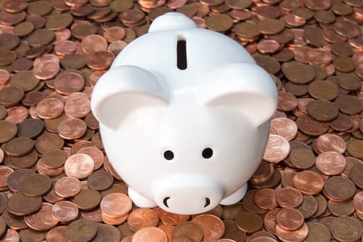 Piggy bank on pile of different Euro cents