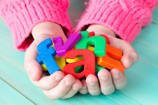 Child learning to read using magnetic letters. Education School  Concept