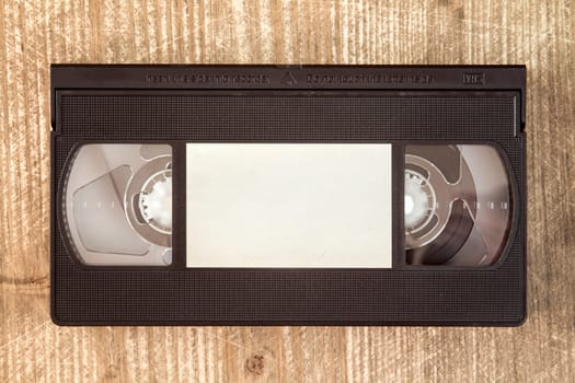 VHS video tape cassette on wooden background.Copy-space.