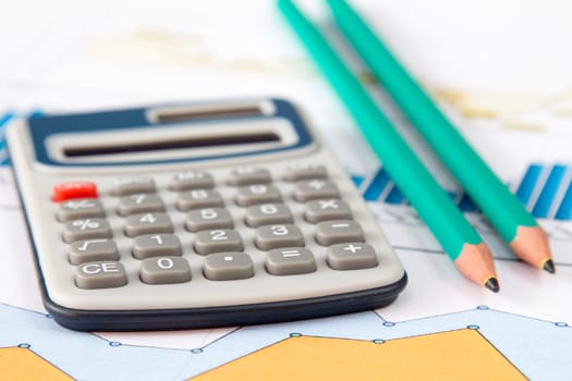 Close-up of a spreadsheet with calculator and two pencils