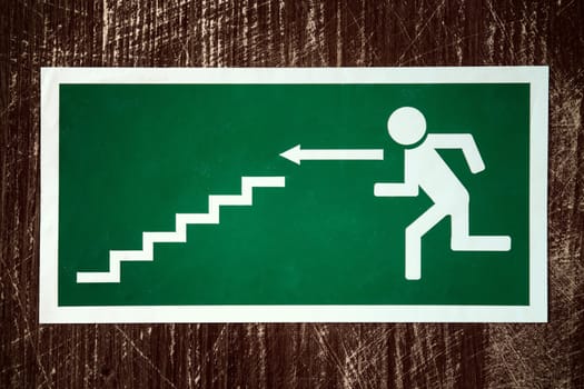 Green emergency fire exit with arrow direction to left side