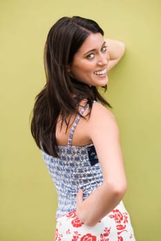 Portrait of a teenage girl smiling with her hand on her hip