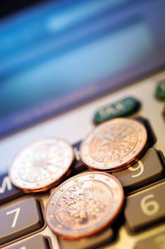 Close-up of Eurocent coins on a calculator
