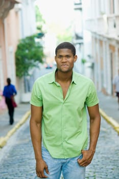 Portrait of a young man standing on the street