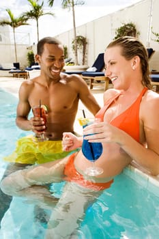 Close-up of a young couple smiling in a swimming pool