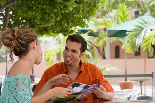 Close-up of a teenage girl and a mid adult man holding a menu in a restaurant